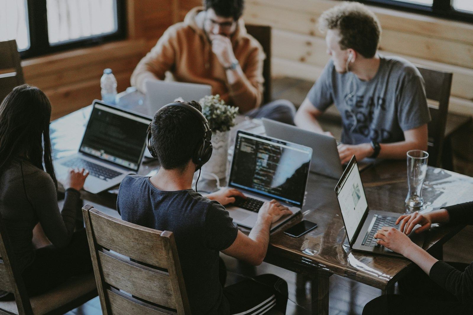 Software team collaborating around laptops